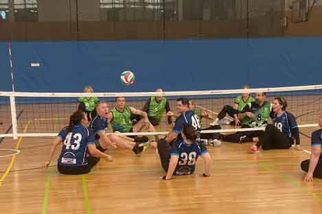 people sitting on the court hitting volleyball