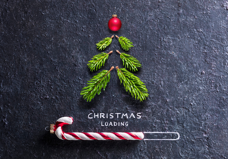 Fern branches and candy cane with the words Christmas loading