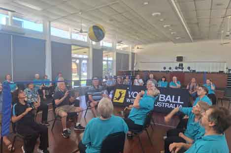 people sitting on chairs playing volleyball