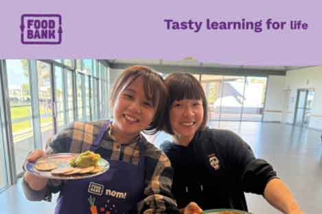two people holding food smiling 