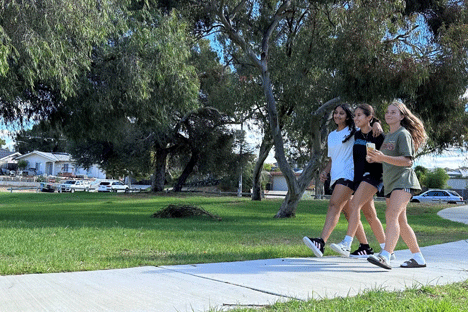 group of three walking outside 