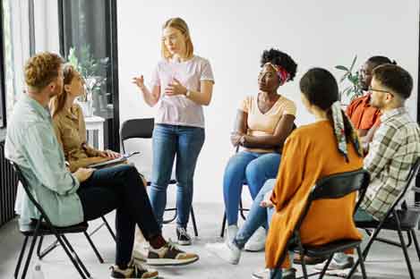 group of people sitting down and talking 