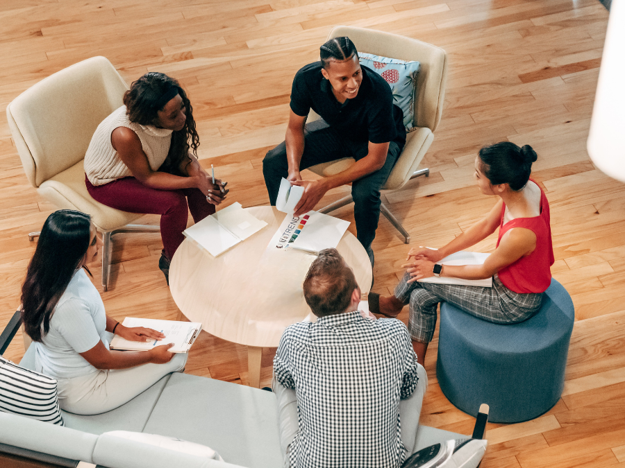 group of people sitting down and talking 